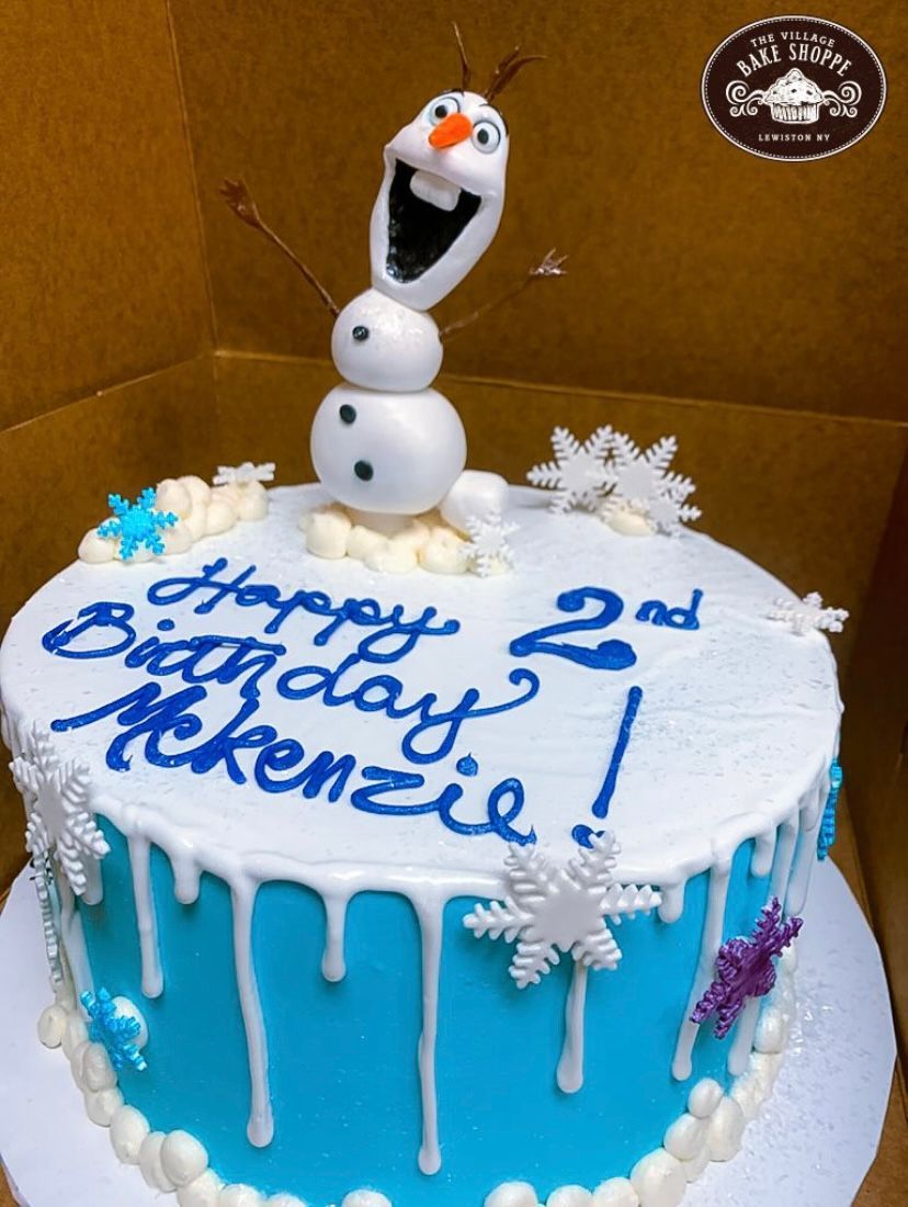 a birthday cake with a snowman on top that says happy 2nd birthday mckenzie
