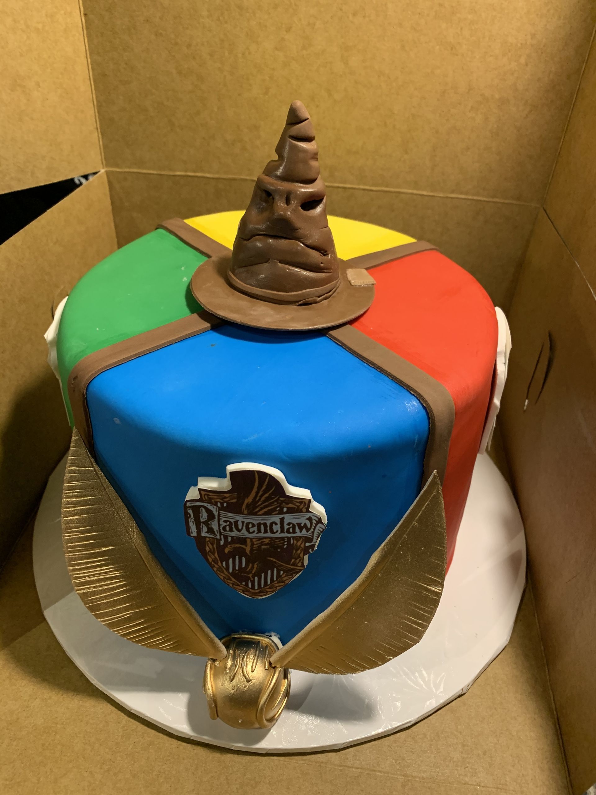 a harry potter cake with a sorting hat on top