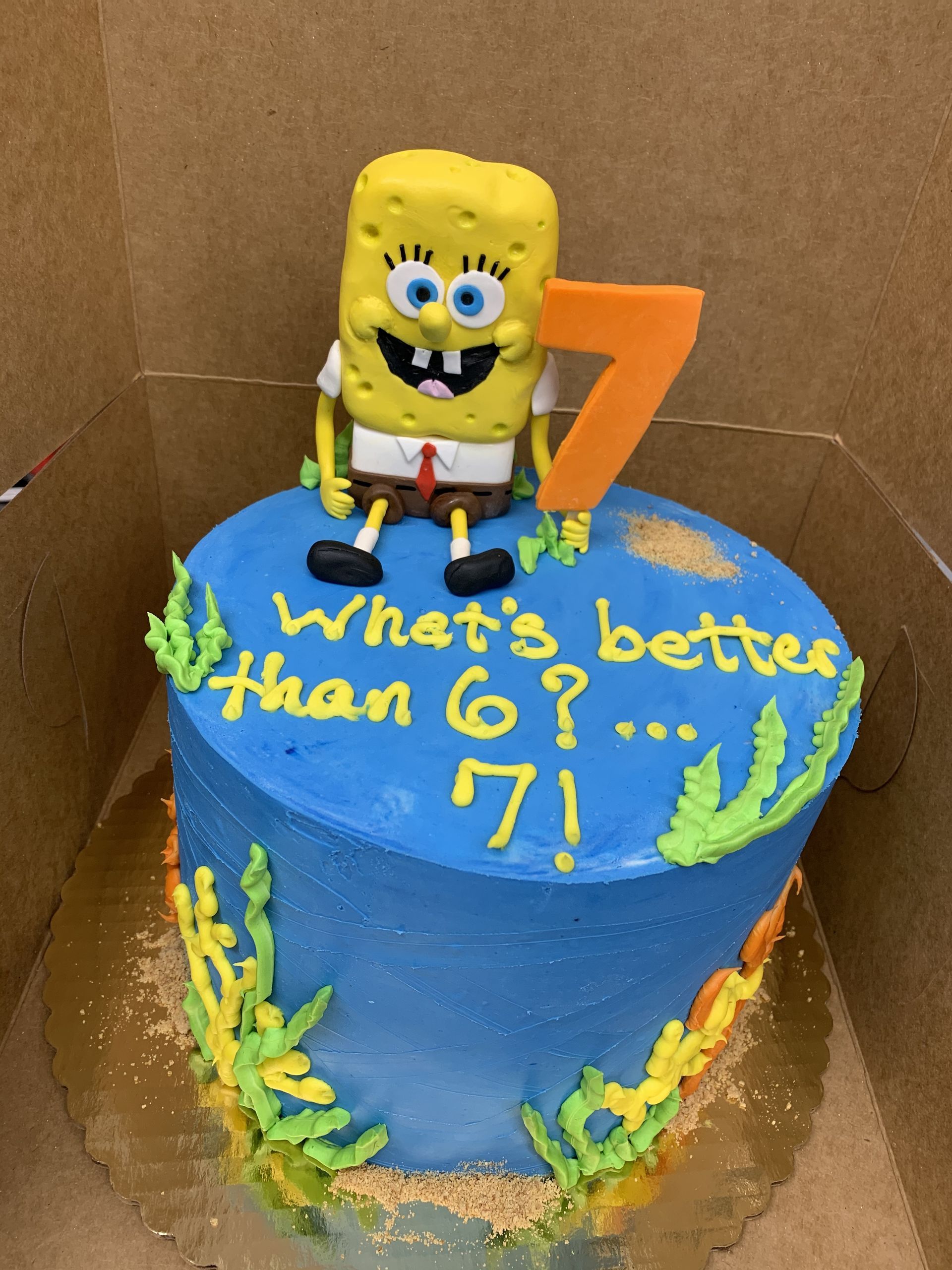 a blue cake with spongebob on top and the words what 's better than 6 7