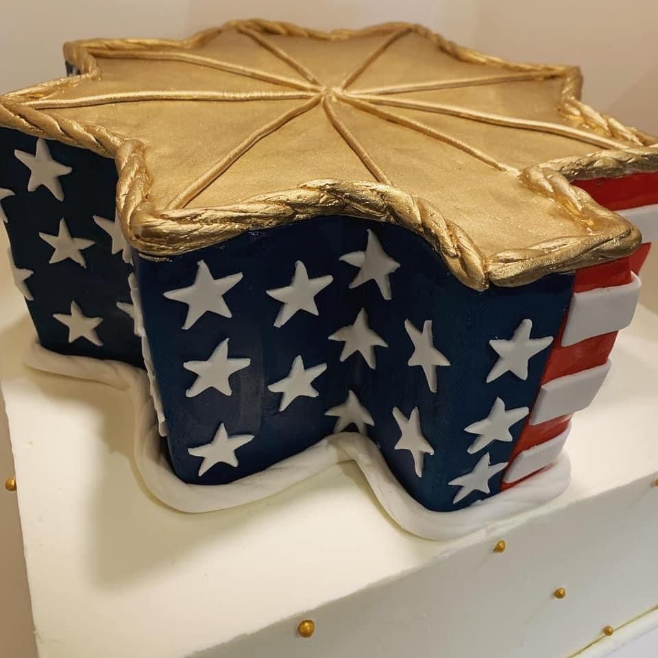 a star shaped cake with red white and blue stars on it