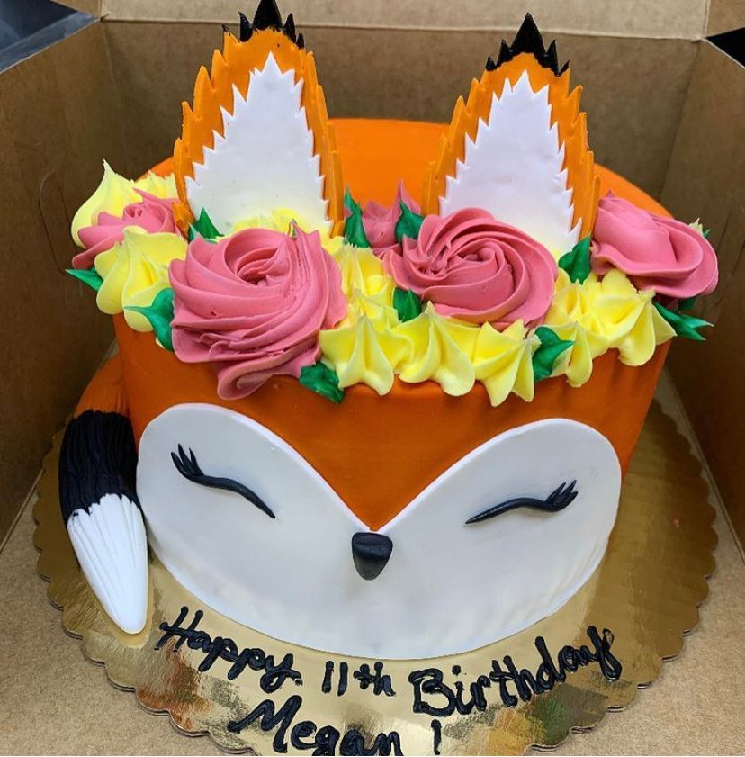 a birthday cake with a fox face on it