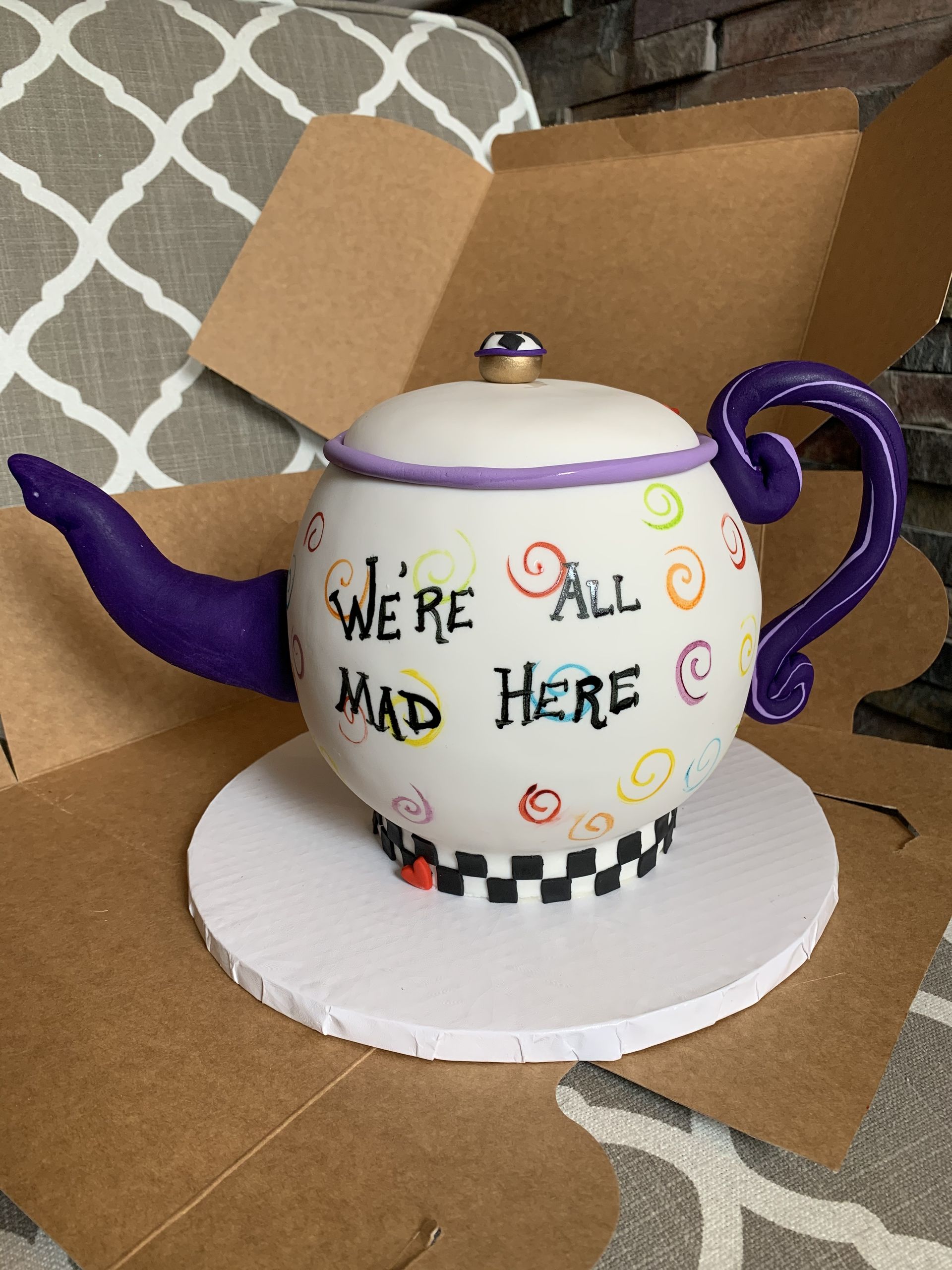 a teapot that says we 're all mad here