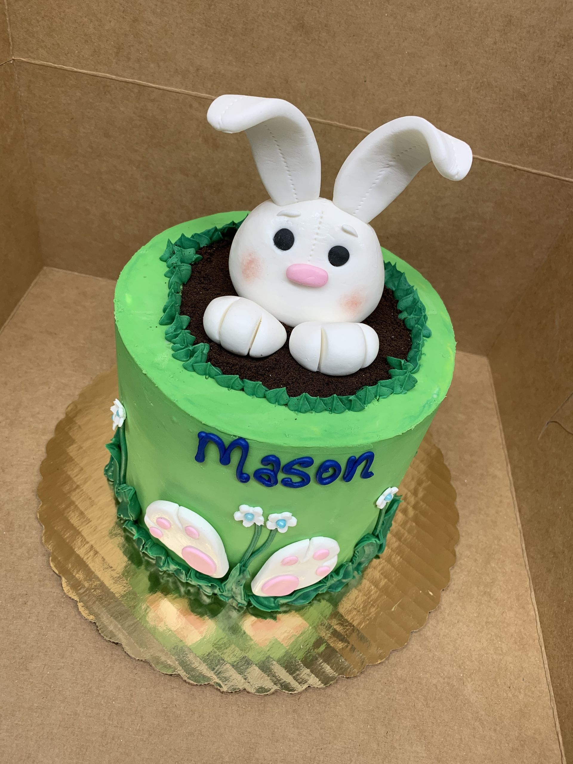 a green cake with the name mason on it