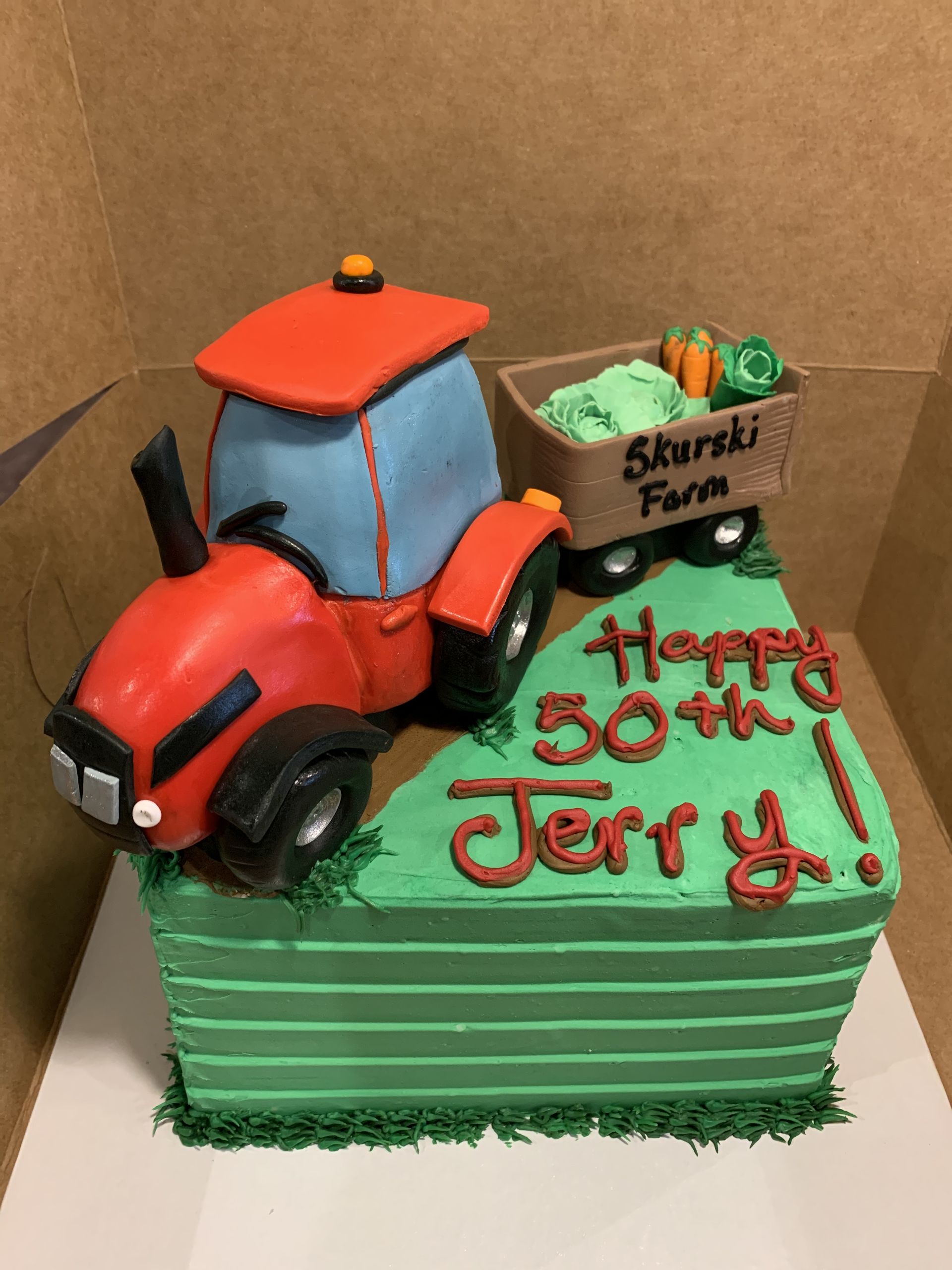 a 50th birthday cake with a tractor on top