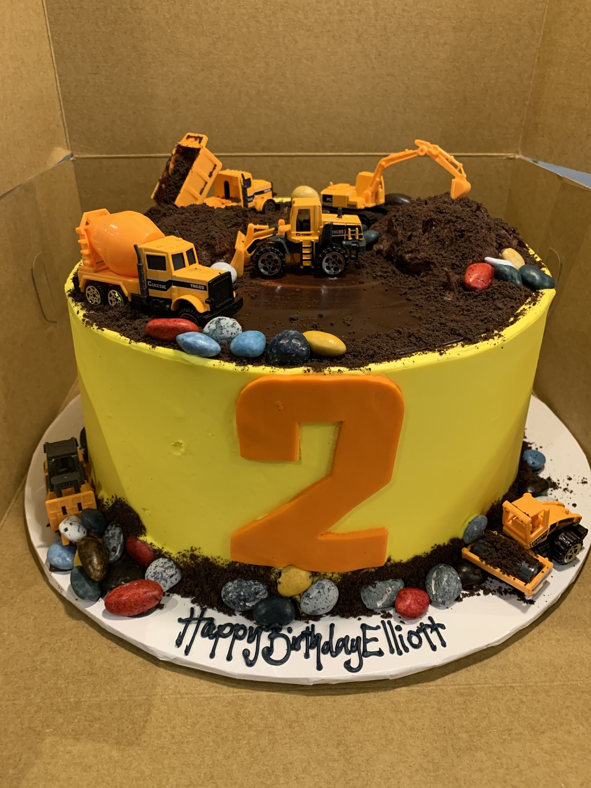 a birthday cake for a boy with construction vehicles on it