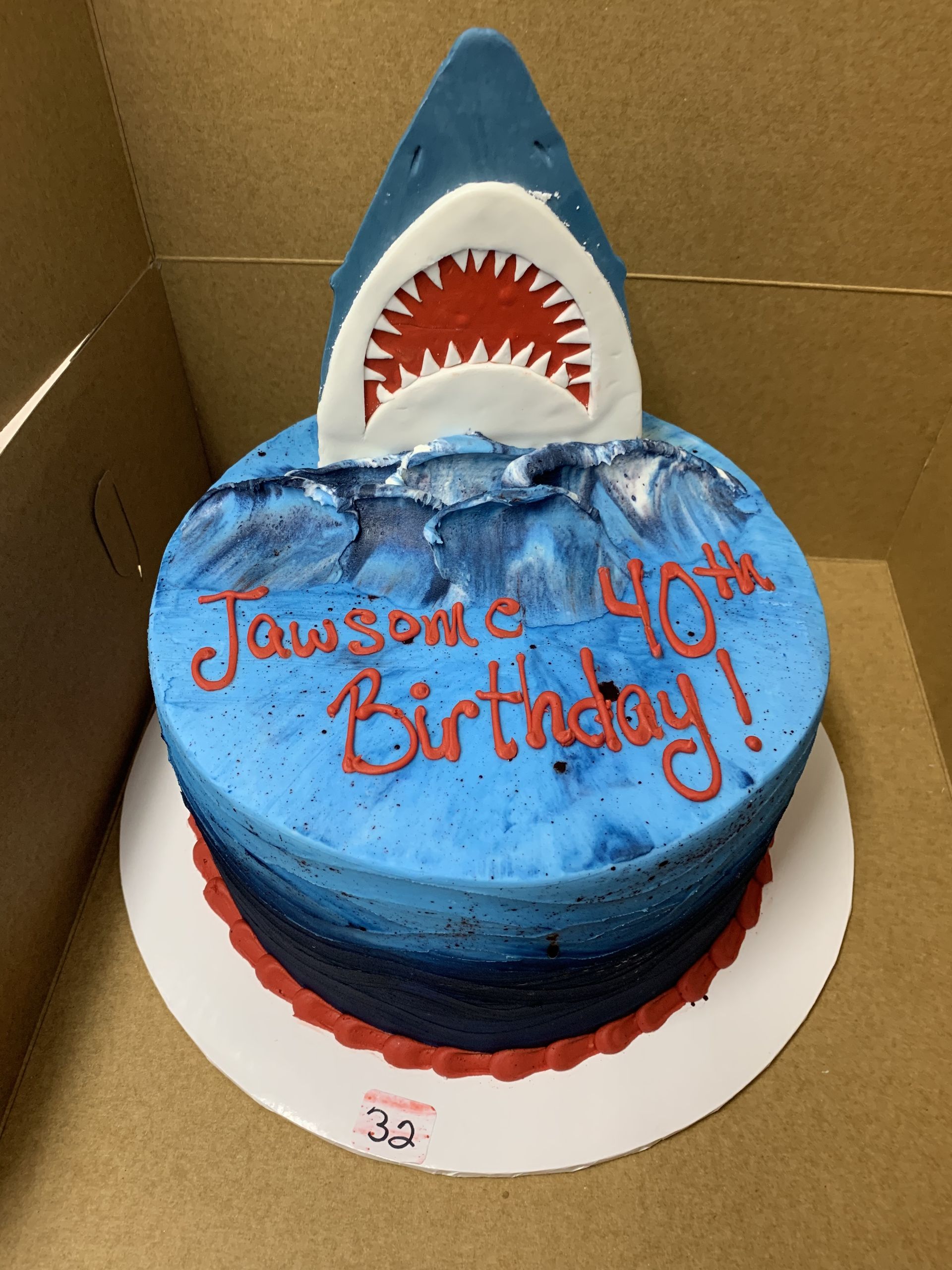 a birthday cake with a shark on top of it