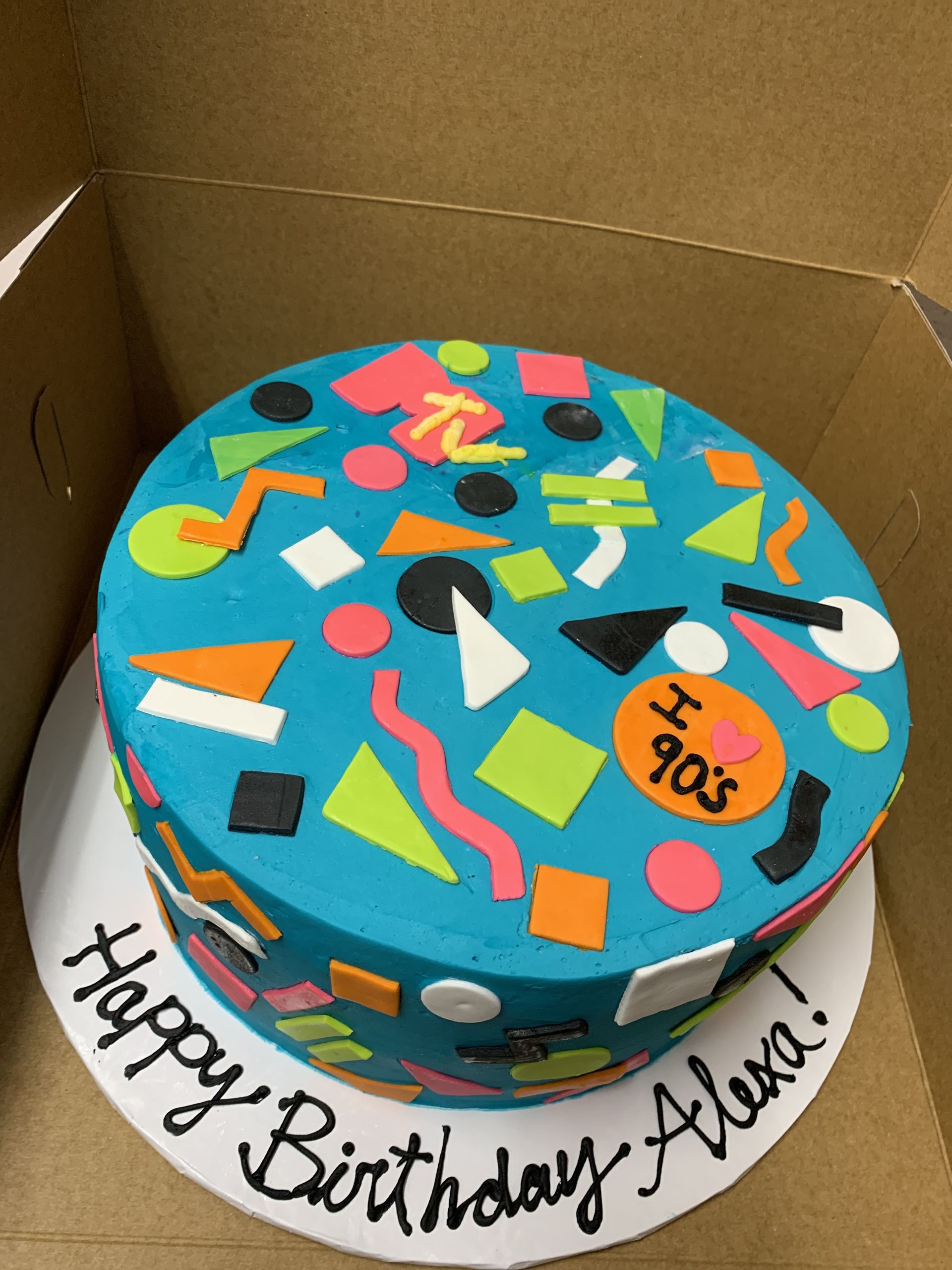 a birthday cake in a box that says happy birthday alexa