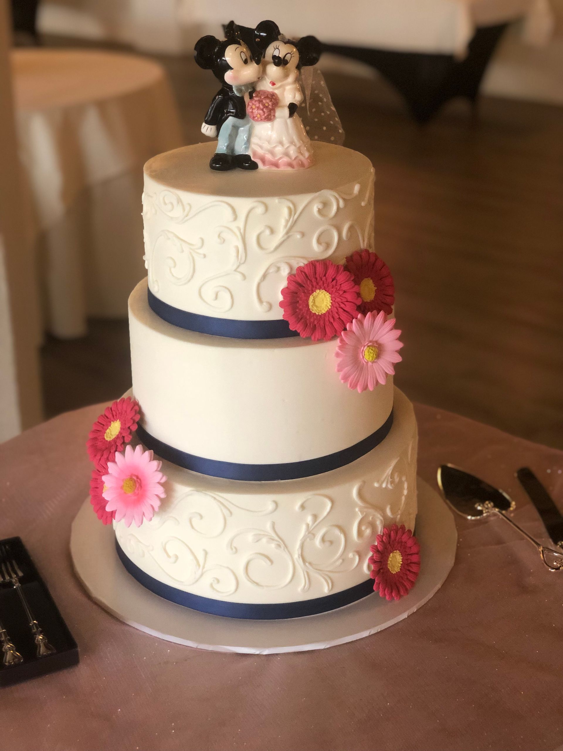 a wedding cake with a bride and groom figurine on top