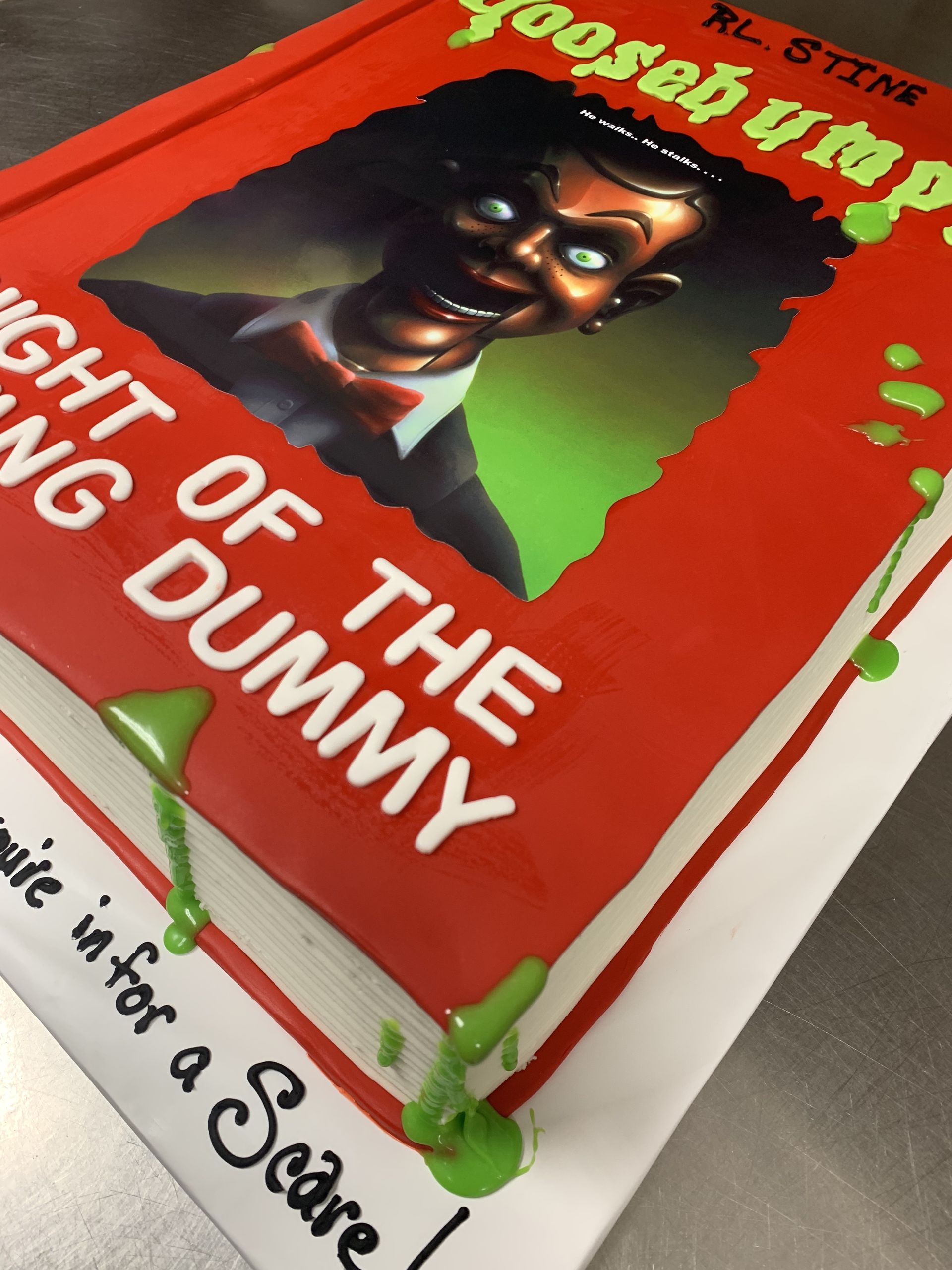a cake that looks like a book called night of the dummy
