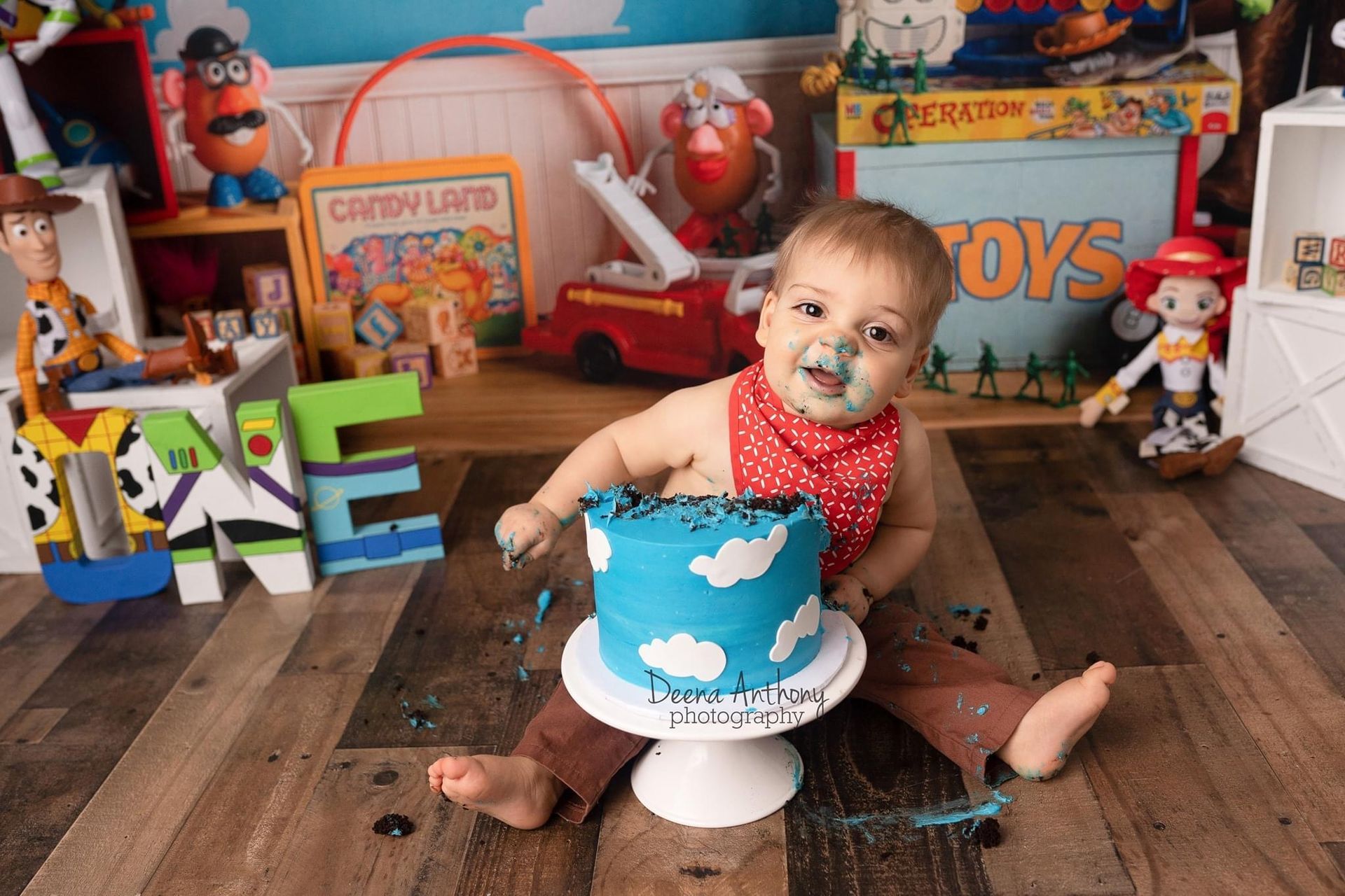 a baby is sitting on the floor eating a cake .
