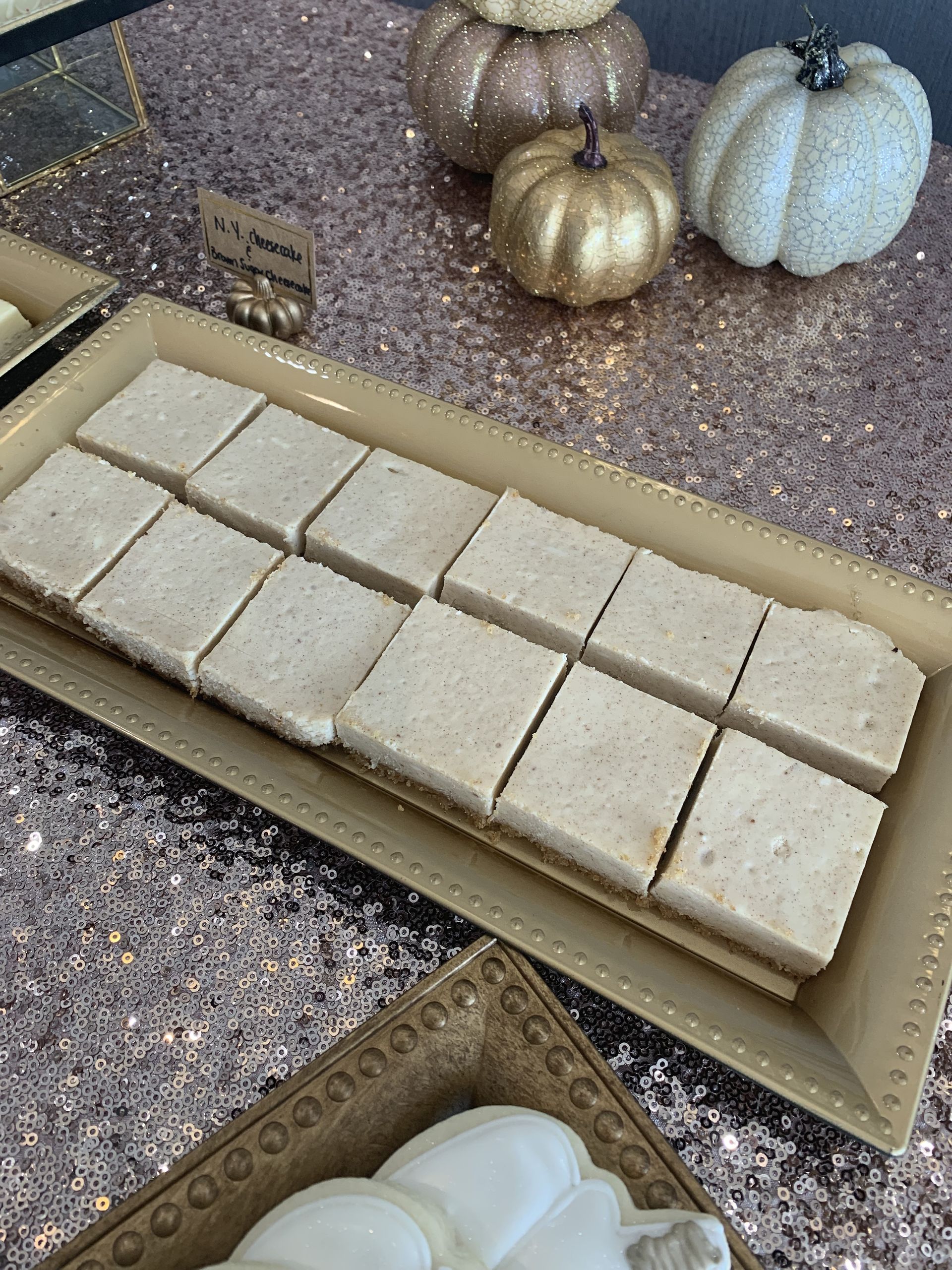 a tray of cookies on a table with pumpkins in the background .