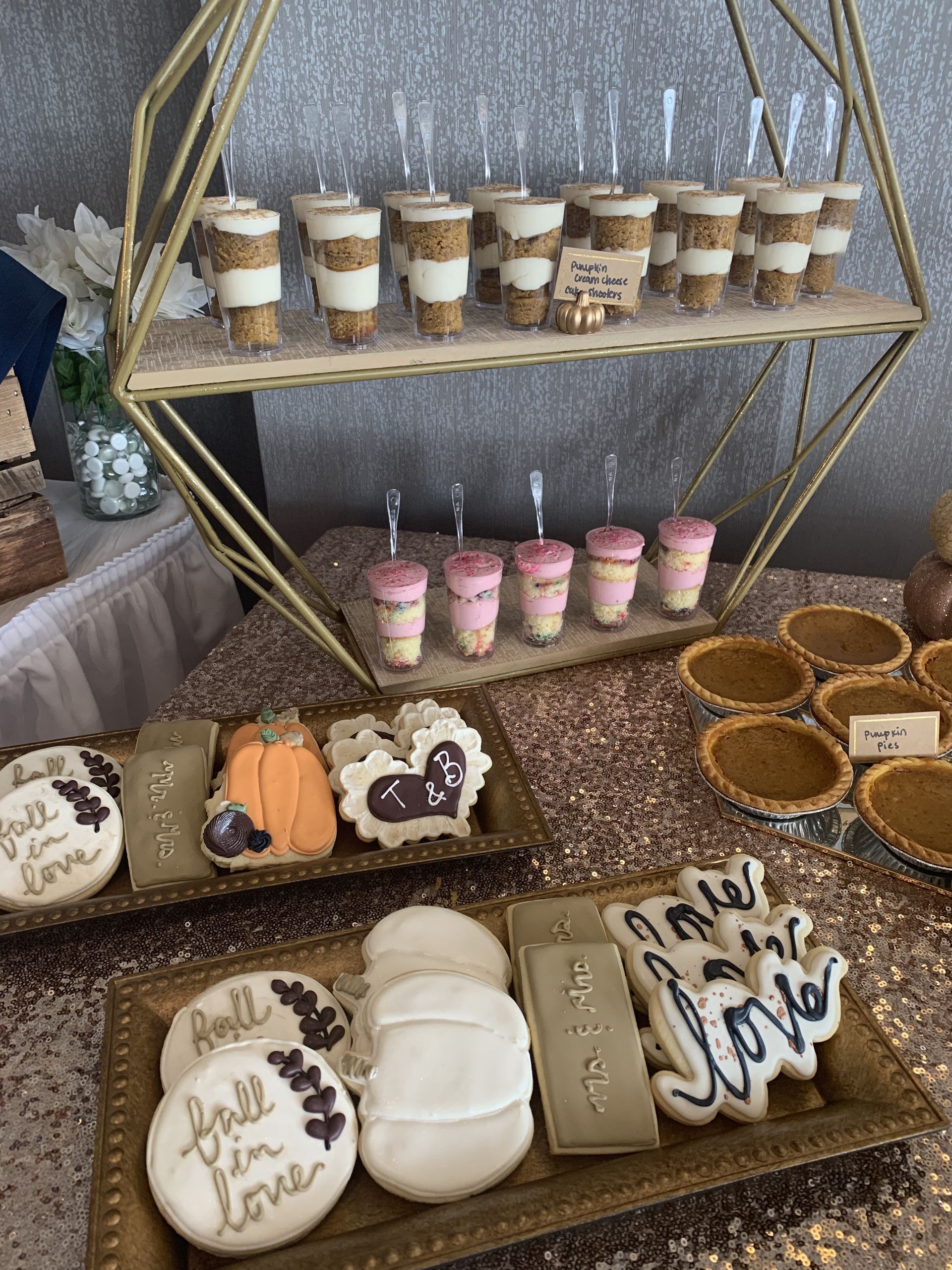 a table topped with plates of cookies and desserts .