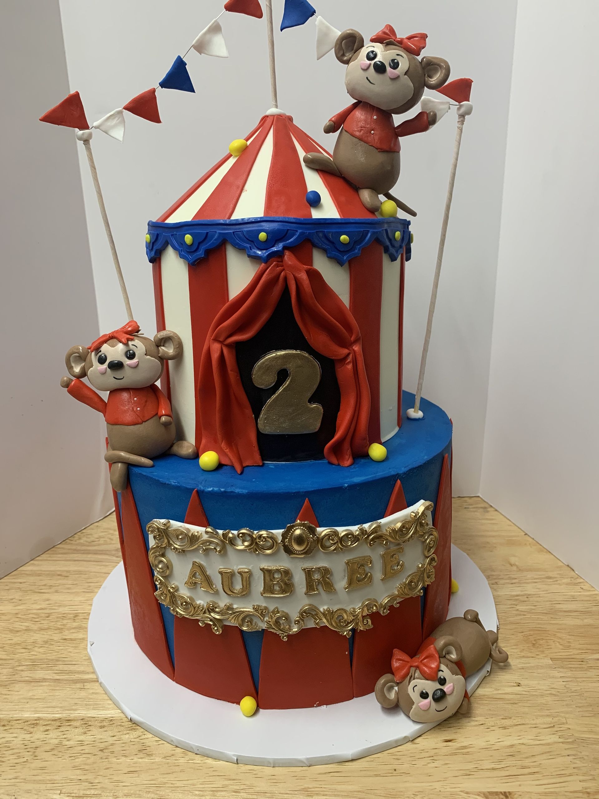 a cake with a circus theme and the number 2 on it