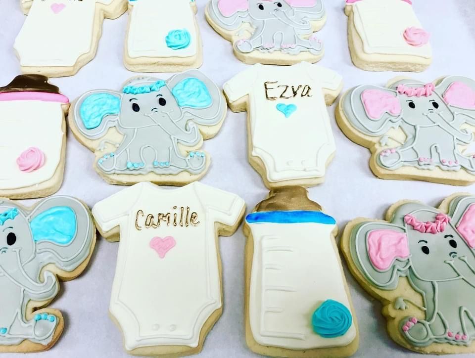 a bunch of baby shower cookies with elephants on them
