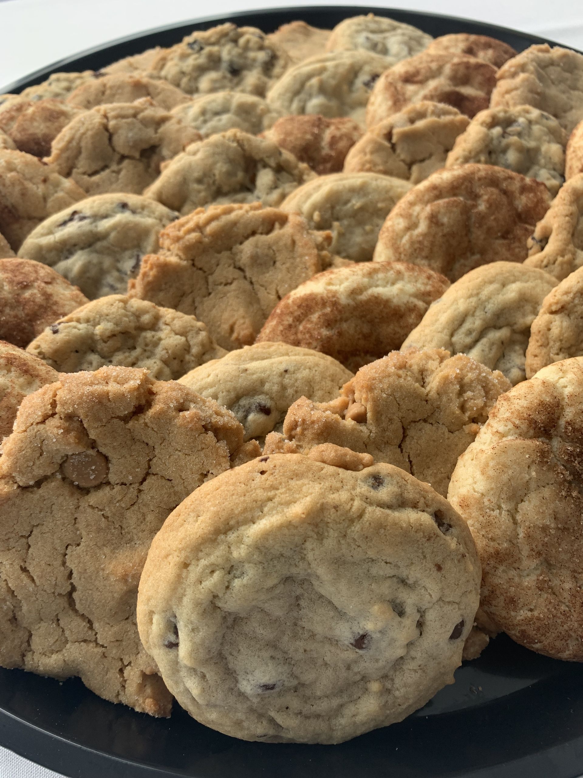 a tray of chocolate chip cookies is sitting on a table .
