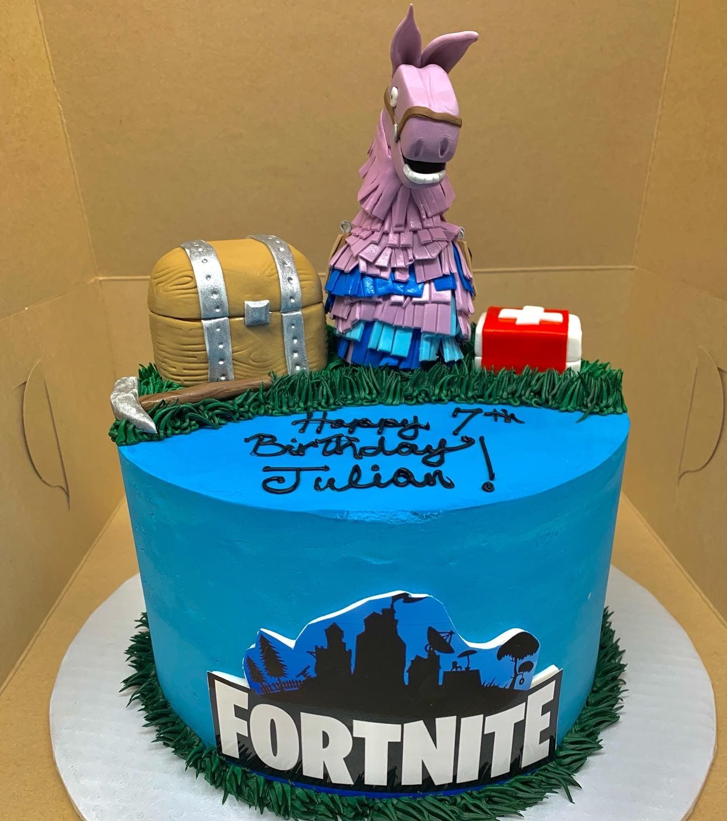 a blue cake with the word fortnite on it