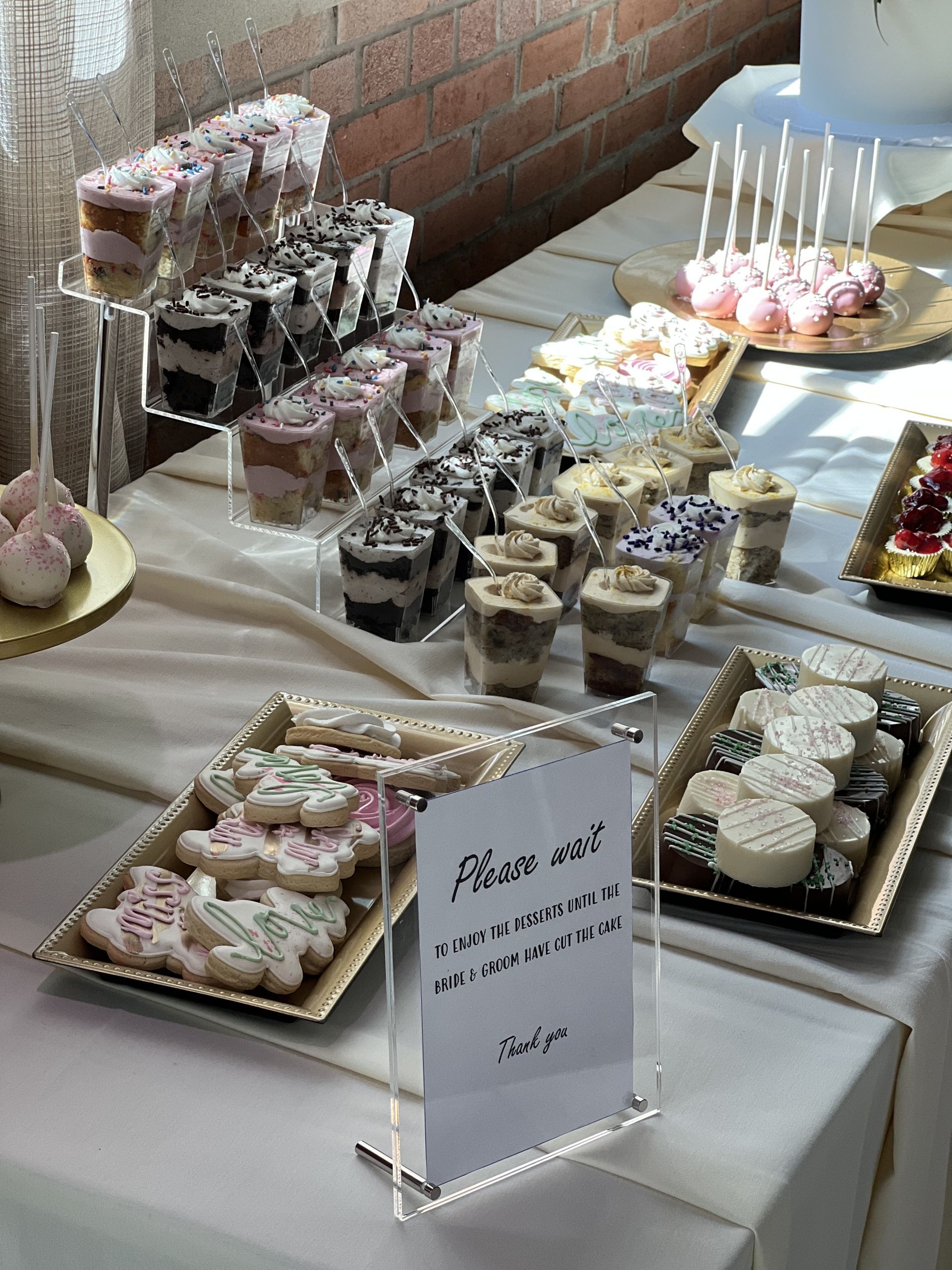 a table topped with a variety of desserts and a sign that says `` thank you '' .