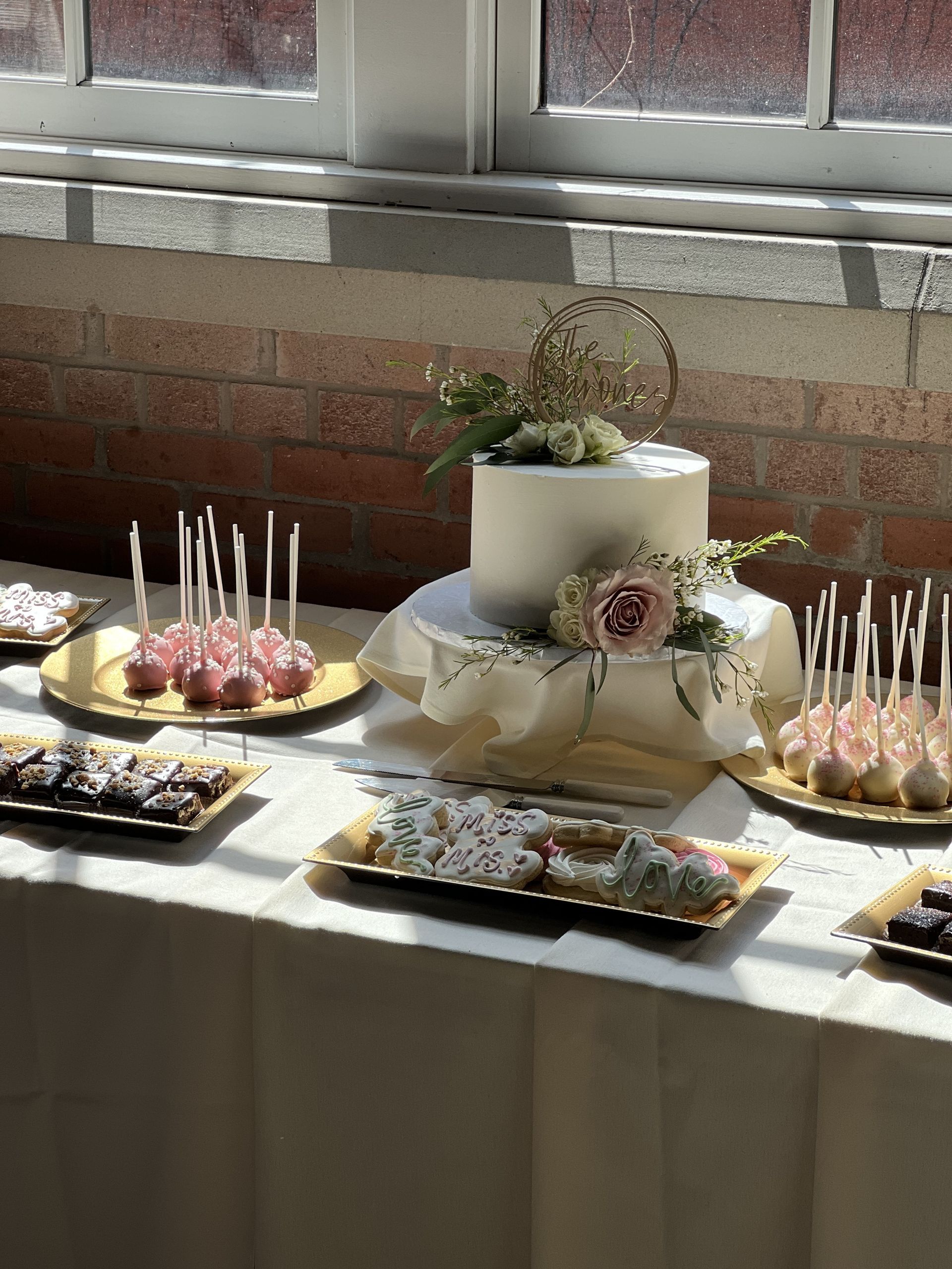 a table with a cake and a variety of desserts on it .