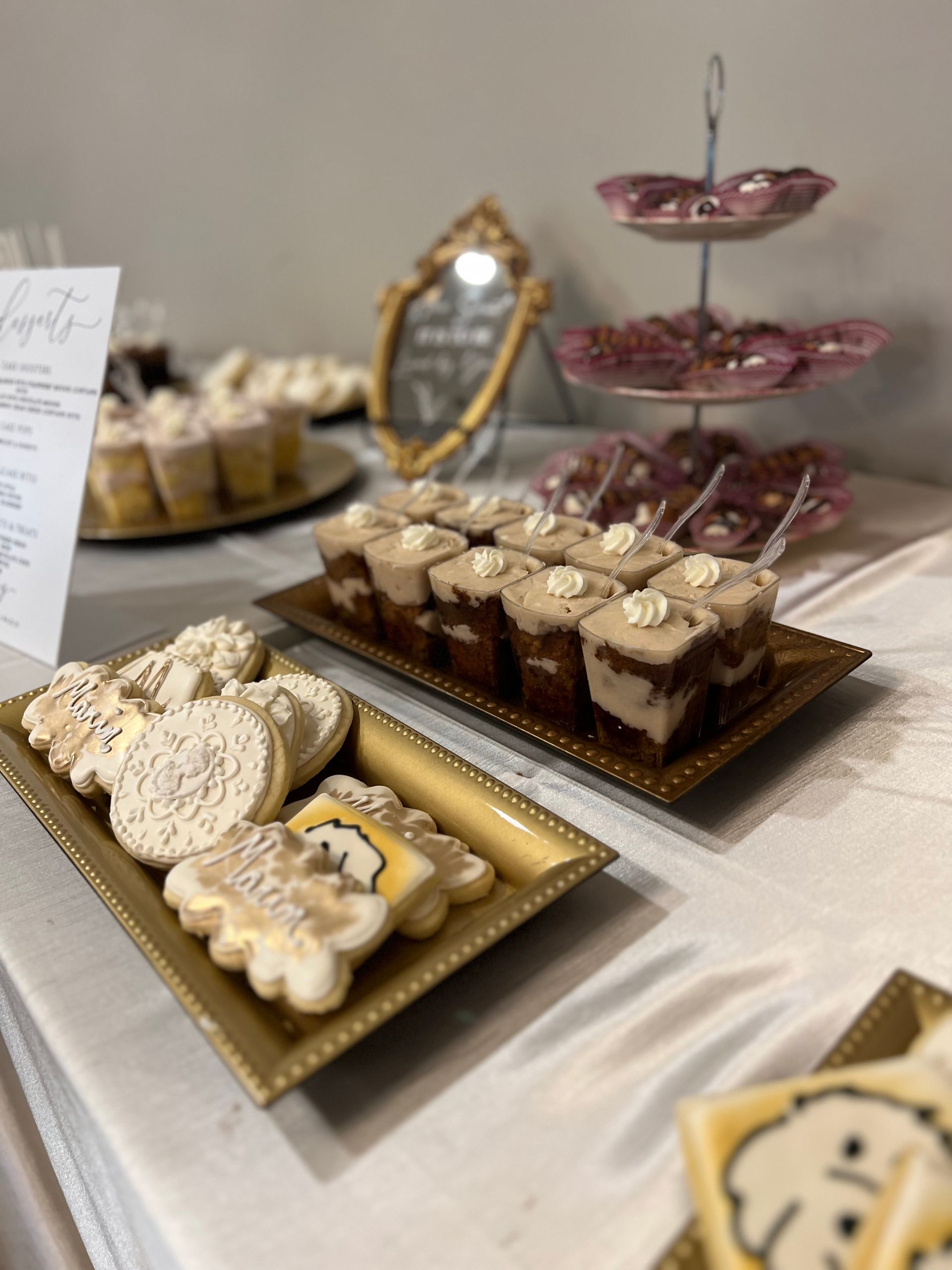 a table topped with a variety of desserts including cookies and cupcakes