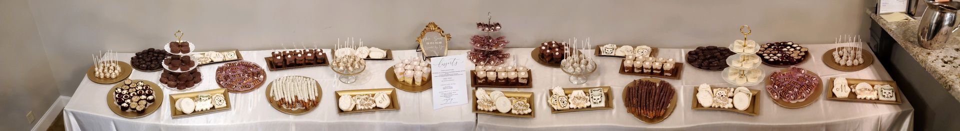 a table with a lot of food on it and a white table cloth .
