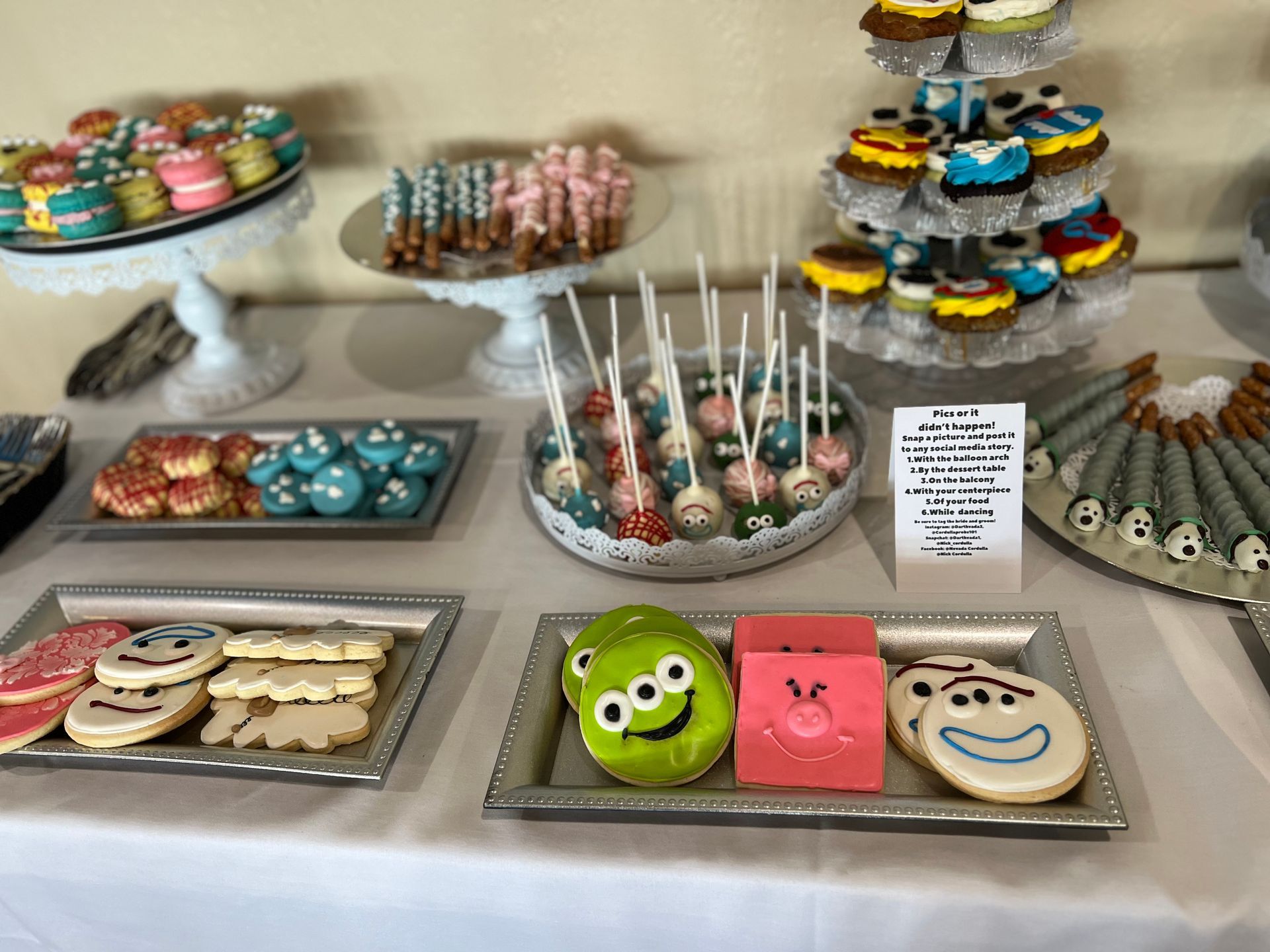 a table topped with a variety of desserts including cupcakes and cookies .