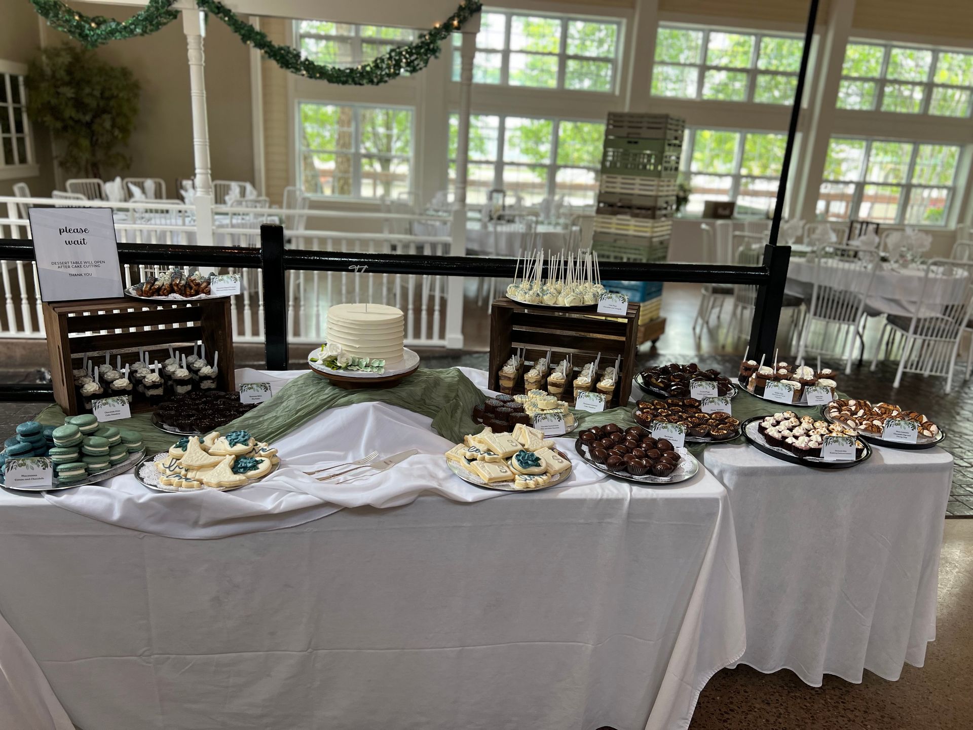 a table with a variety of desserts on it in a room .