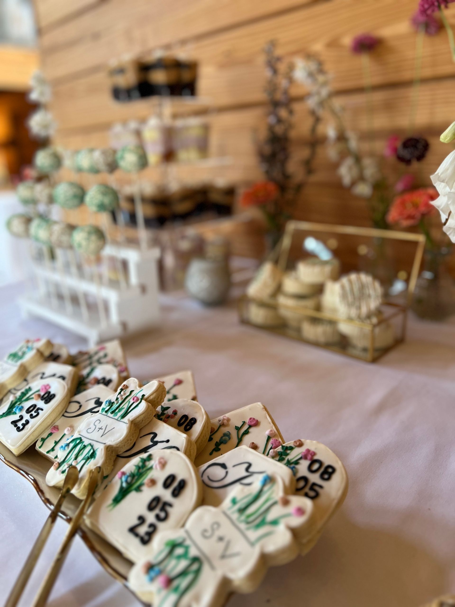 a bunch of cookies on sticks on a table