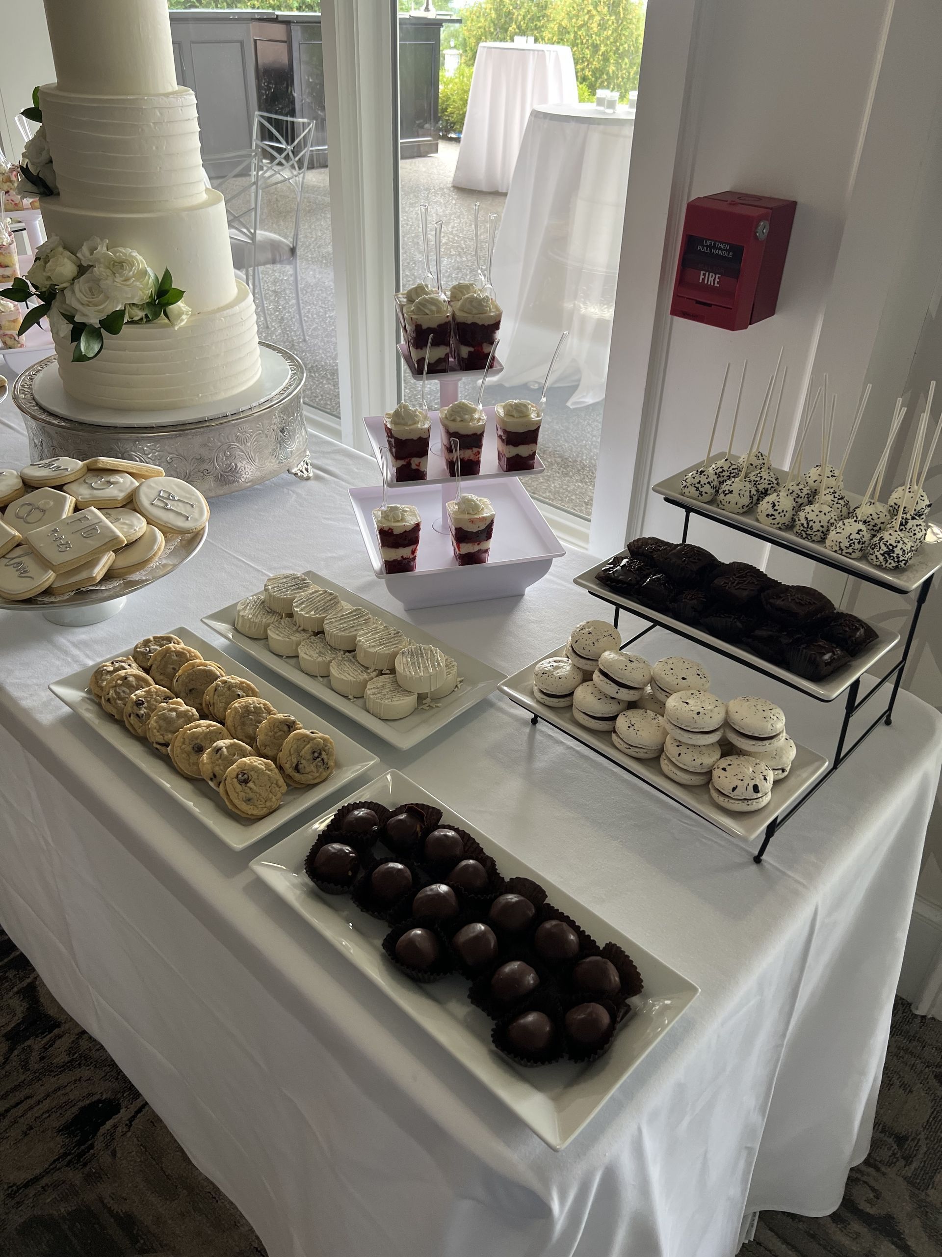 a table with a cake , cupcakes , cookies and other desserts on it