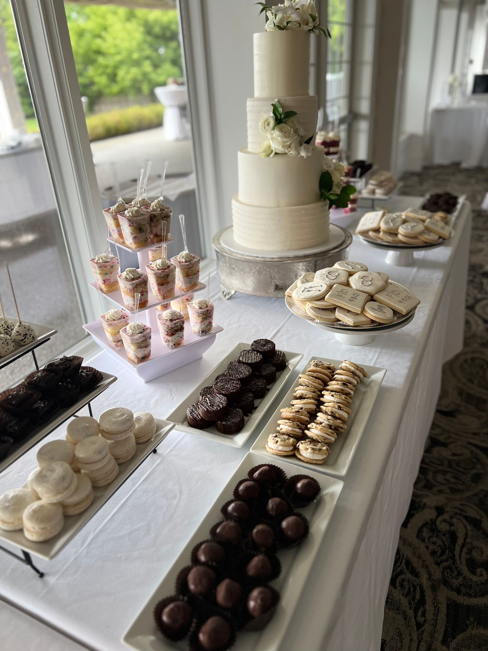 a table topped with plates of desserts and a cake .