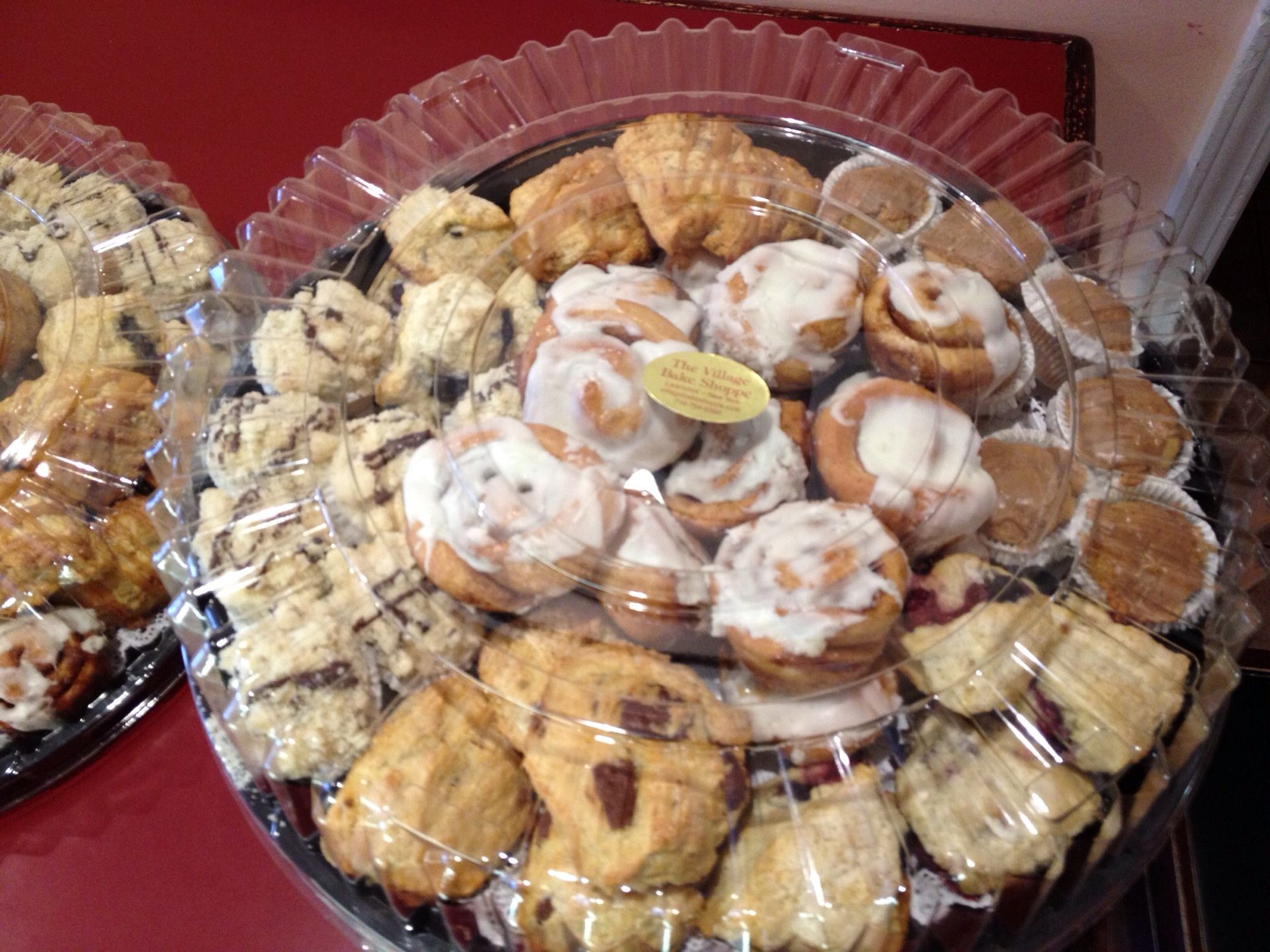 a plastic tray filled with a variety of pastries on a table .