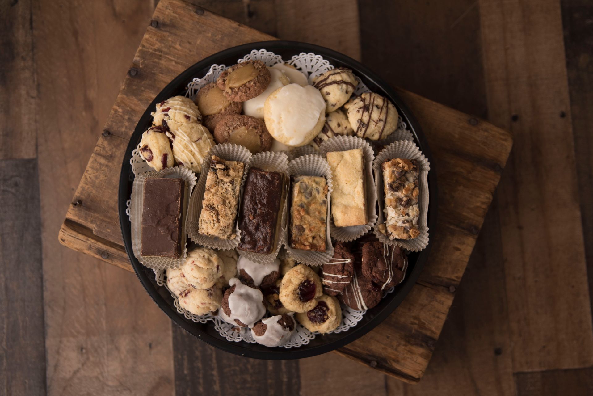 a tray of cookies is sitting on a wooden table .