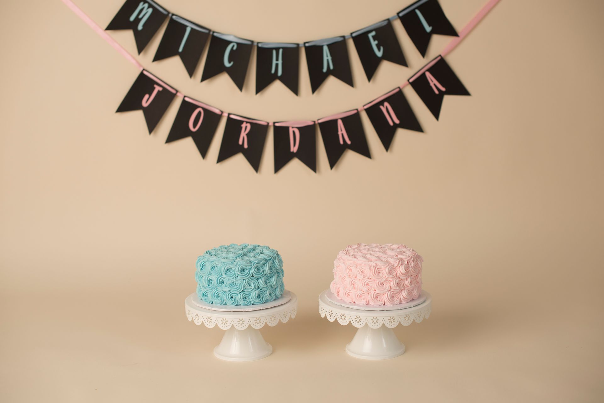 two cakes on a cake stand under a banner that says jordan