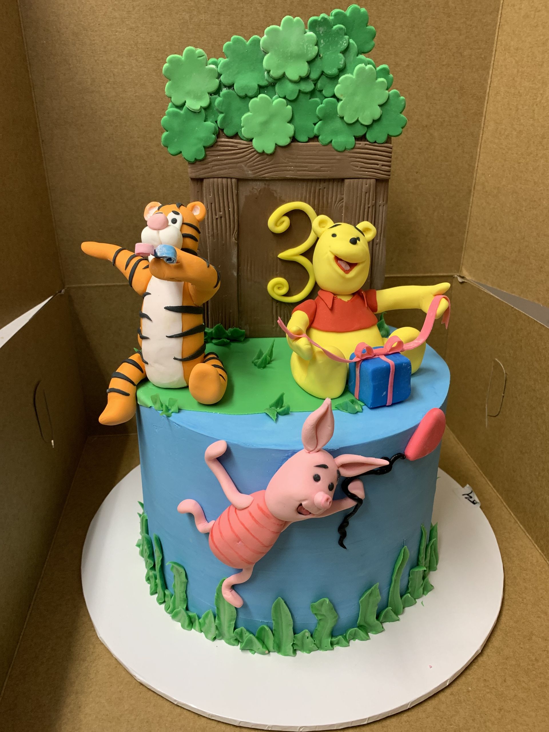 a cake with winnie the pooh tigger and piglet on it