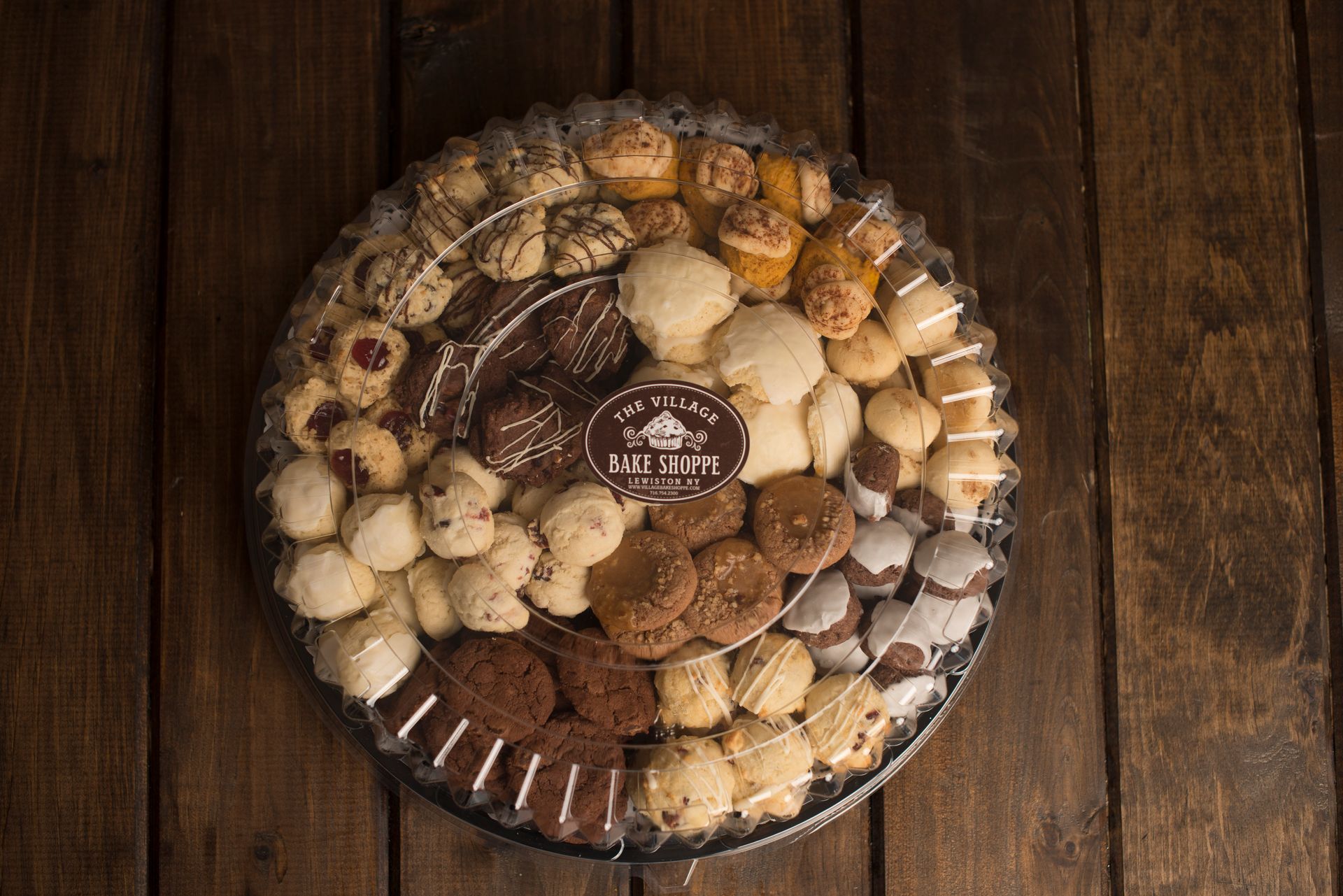 a tray of cookies is sitting on a wooden table .