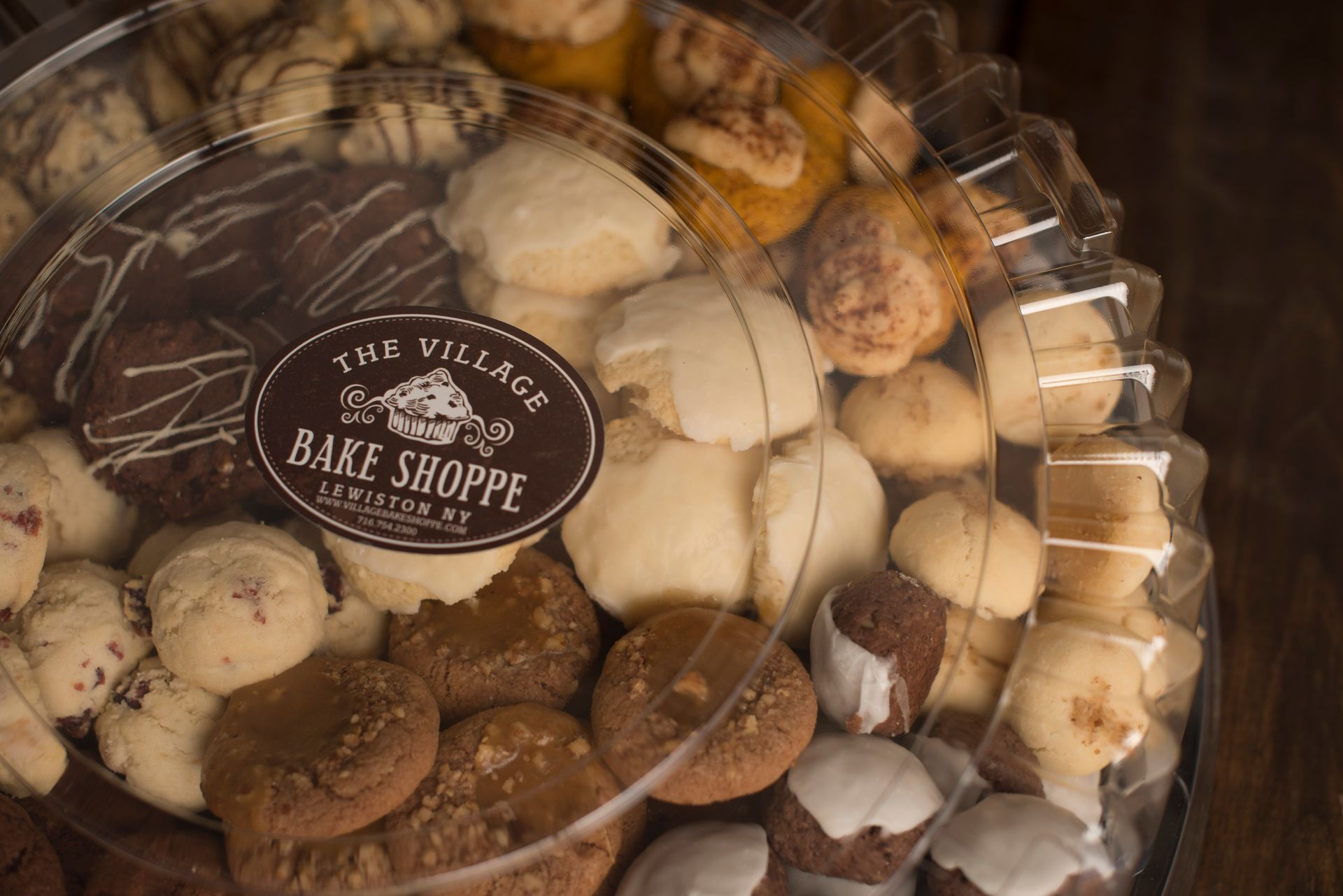 a plastic container filled with different types of cookies .
