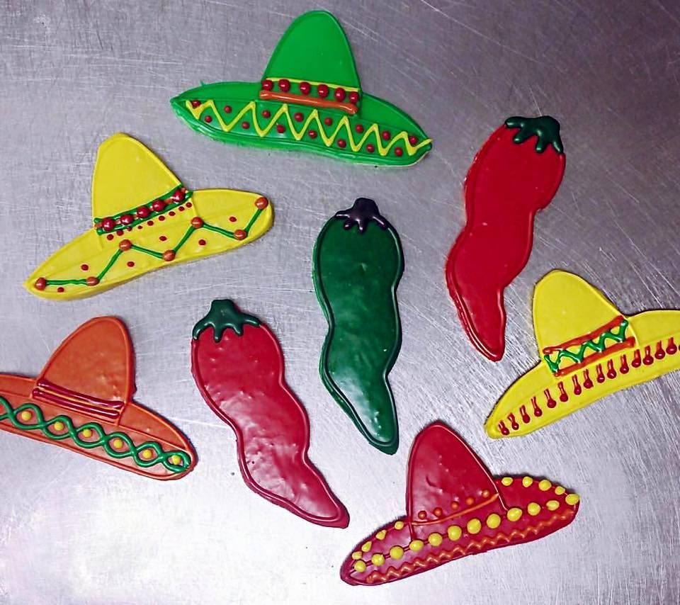 a bunch of mexican hats and peppers on a table