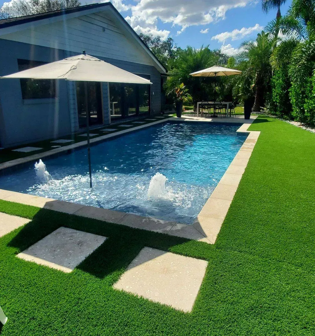 A large swimming pool with a fountain in the middle