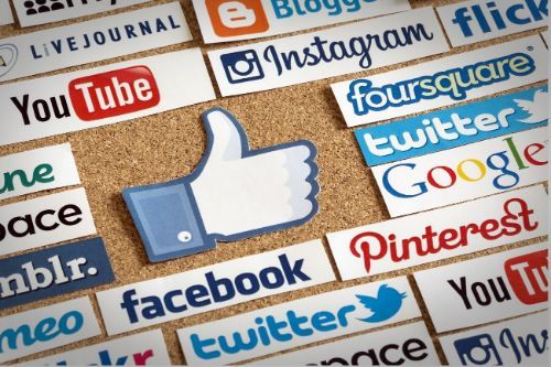 A facebook thumbs up surrounded by other social media icons