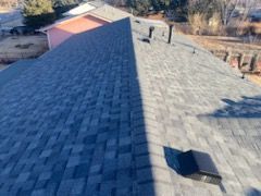 A close up of a roof with a shadow on it.