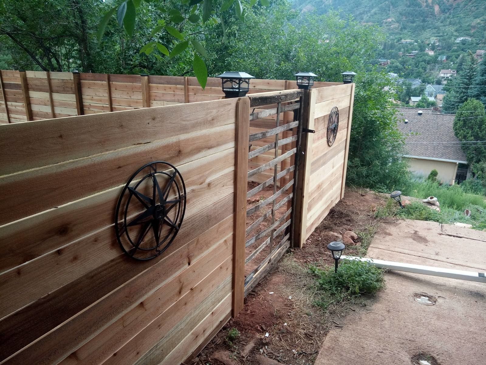 A wooden fence with a star on it and a gate
