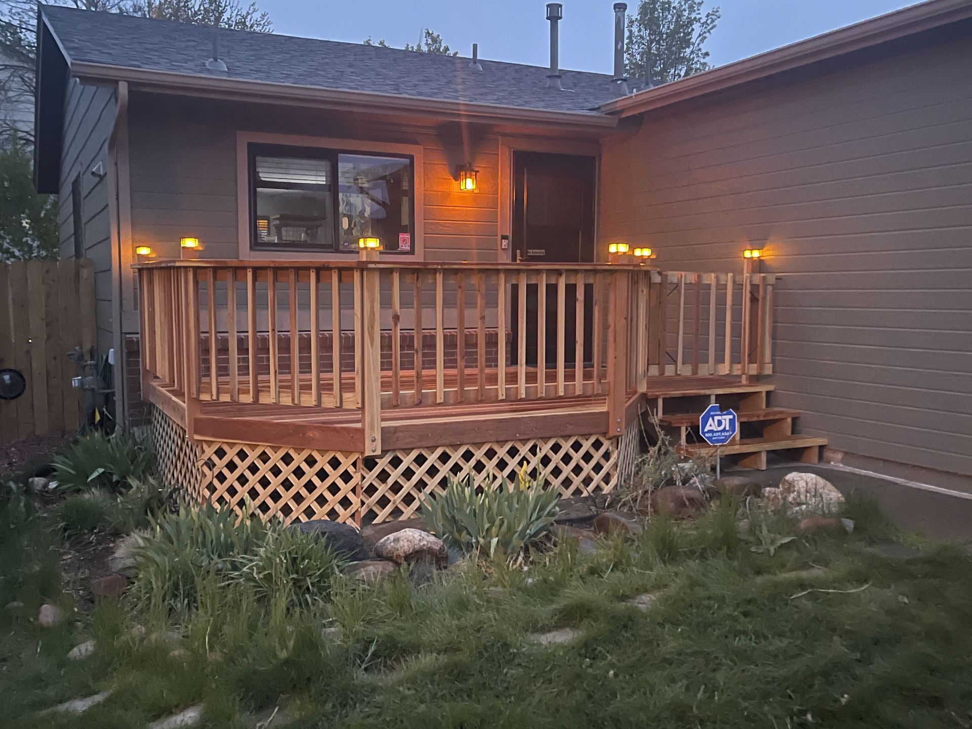 A small house with a wooden deck in front of it