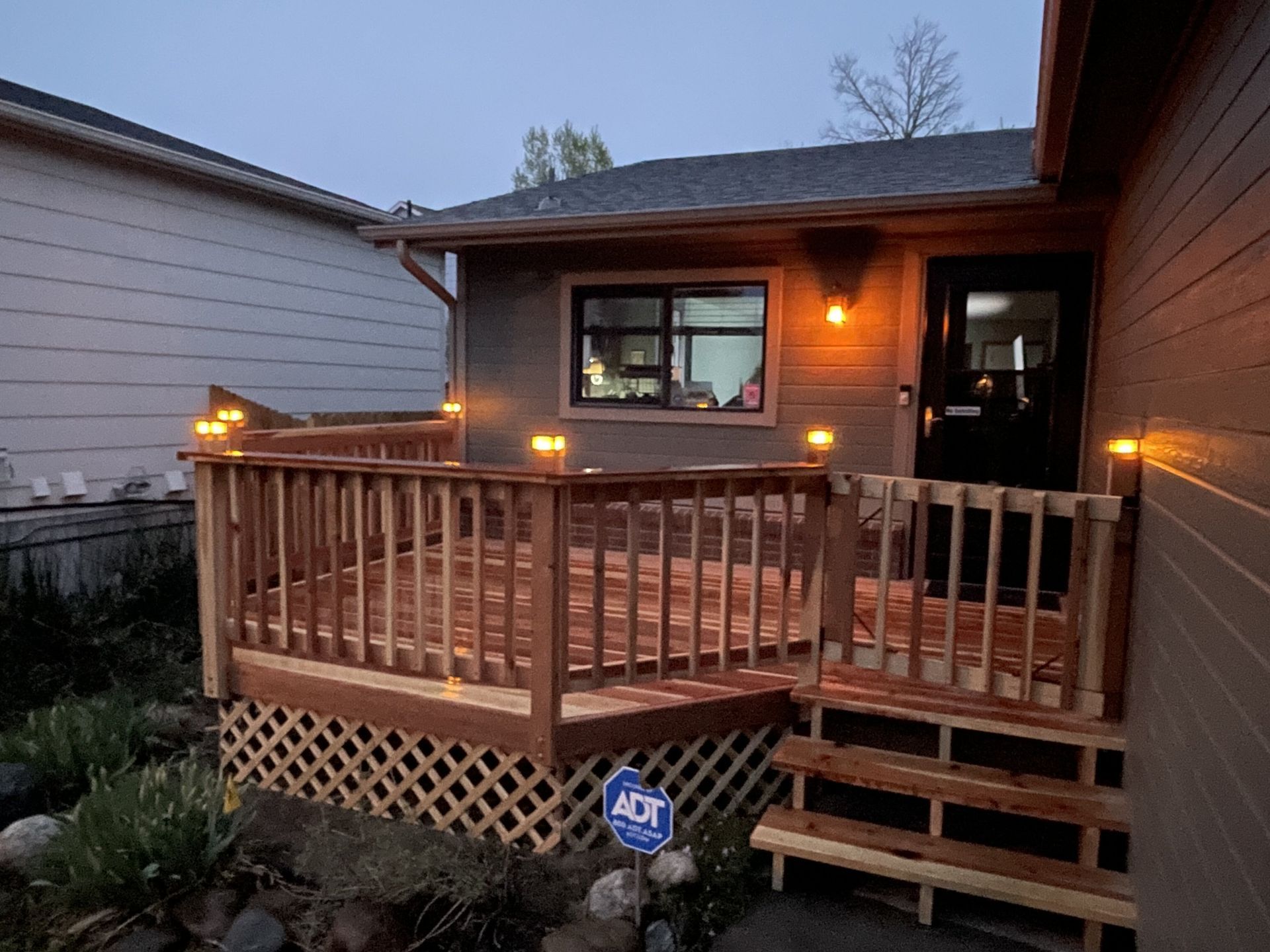 A house with a wooden deck in front of it