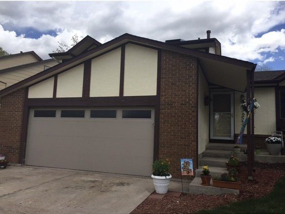 The front of a house with a large garage door