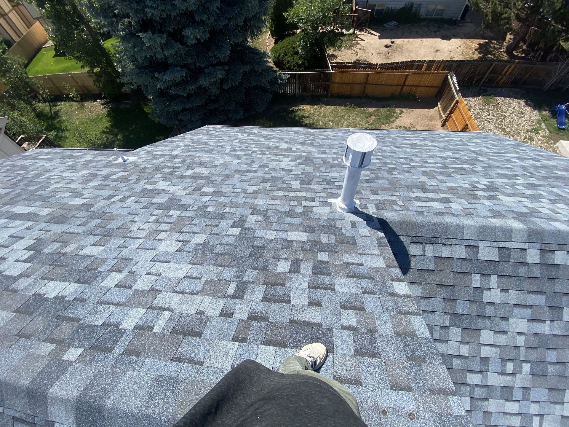 An aerial view of a roof with a pipe on it
