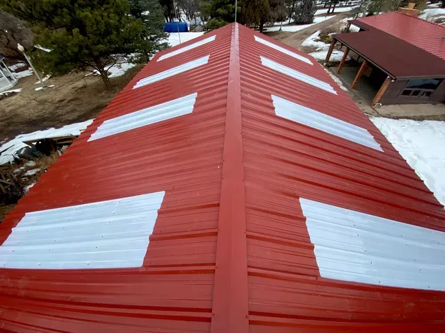 A red roof with white stripes on it