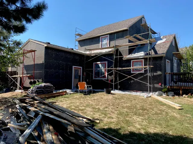 A house is being remodeled with scaffolding around it.