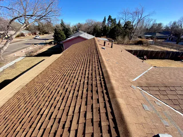 The roof of a house has a lot of shingles on it