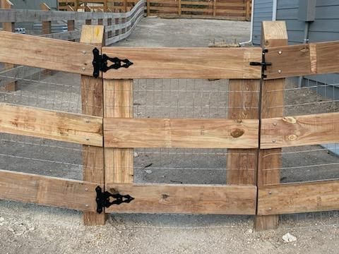 A wooden fence with a metal fence behind it
