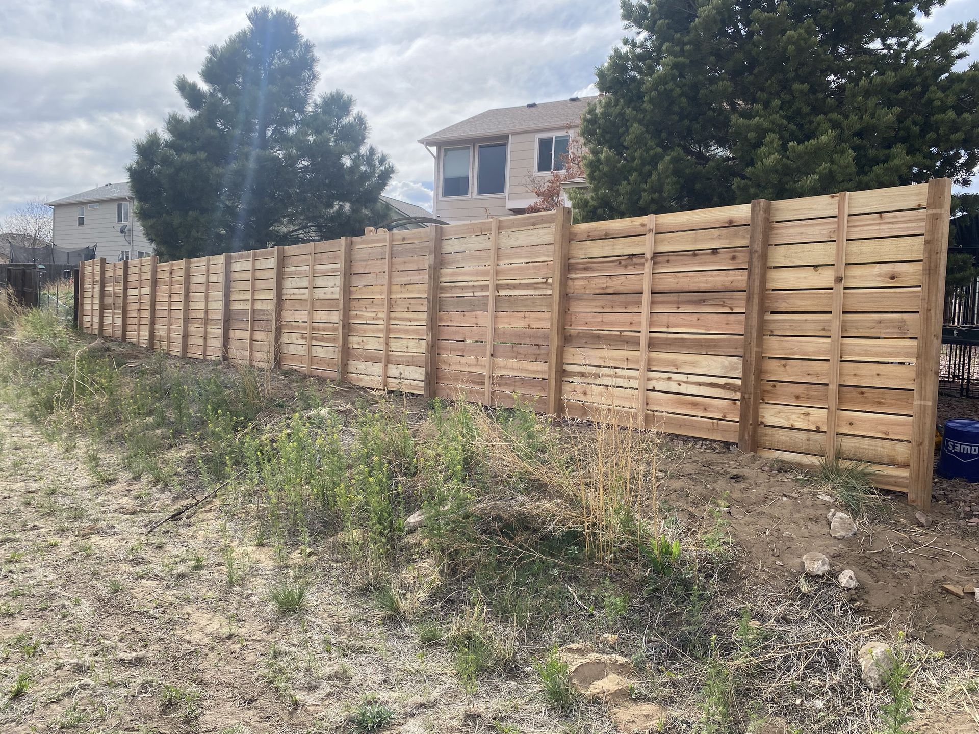 A wooden fence is sitting in the middle of a field.