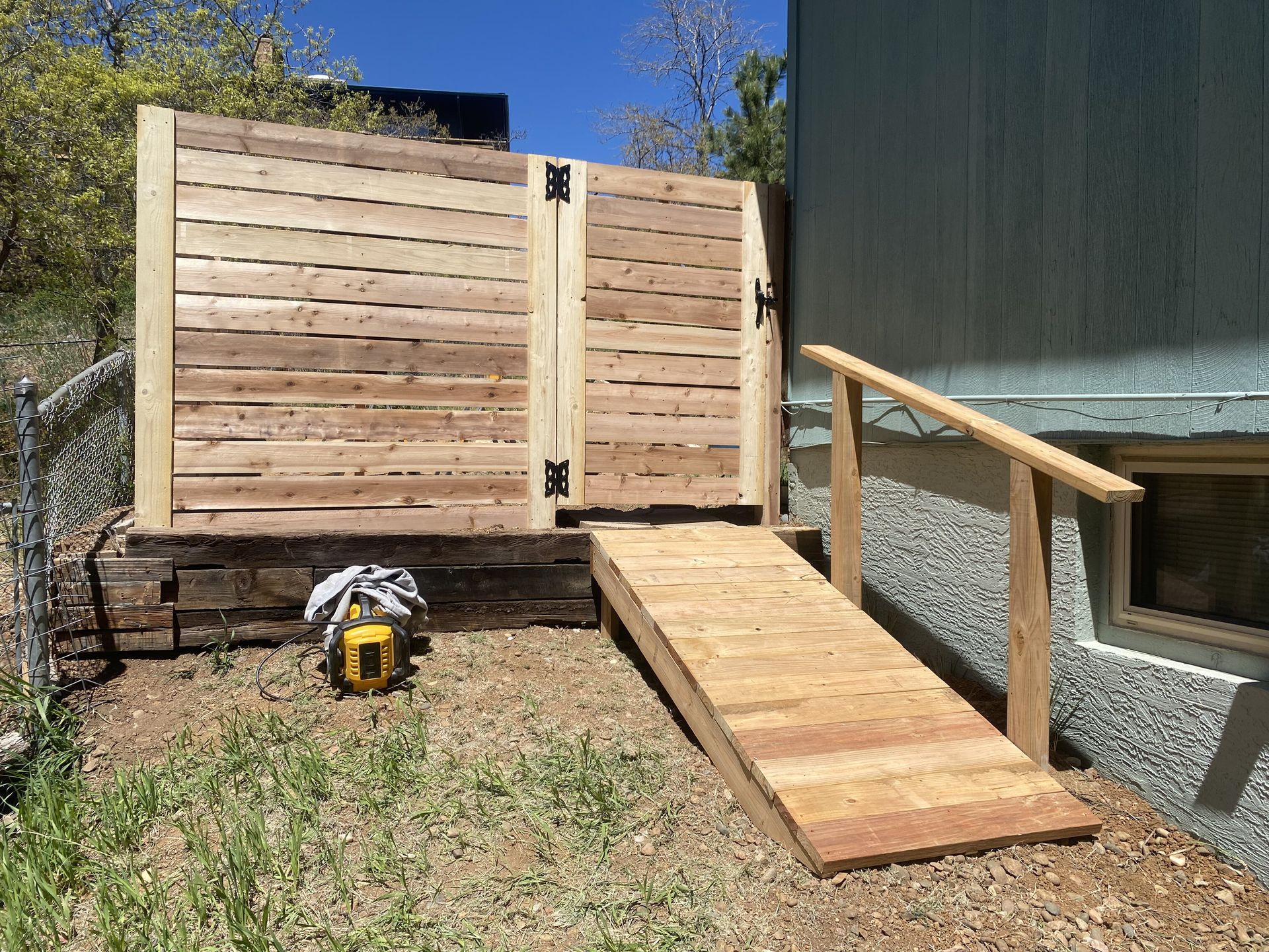 A wooden fence with a ramp leading to it
